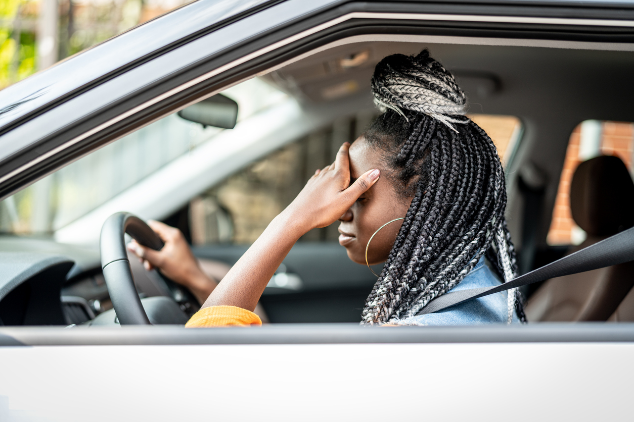 Portrait Of Stressed African Woman In Car