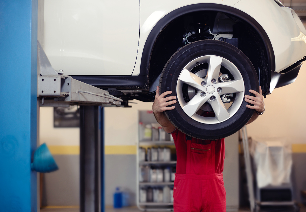 Mechanic Behind Tire