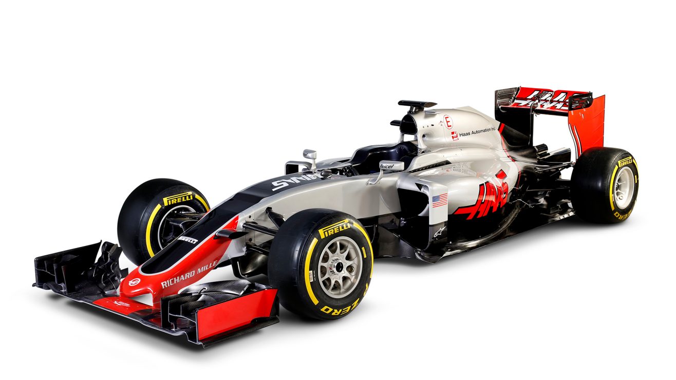 Carro de fórmula 1 da Haas com detalhes prata, branco e vermelho em foto de estúdio com fundo totalmente branco