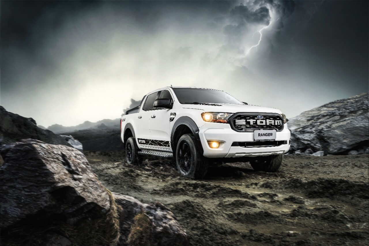 Ford Ranger Storm branca estacionada em uma terreno de pedras com a simulação de um relâmpago no céu ao fundo