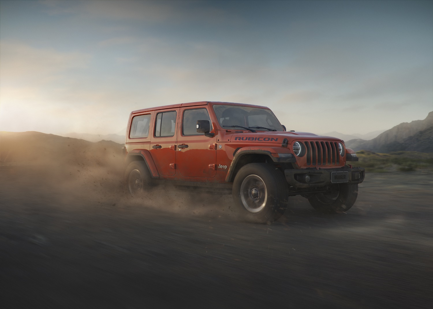 Jeep Wrangler Rubicon laranja fazendo um trilha na areia e levantando poeira meio de lado