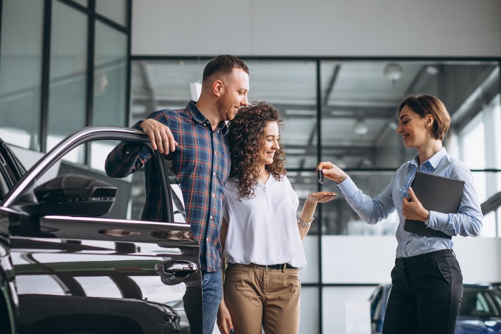 Young Couple Choosing A Car In A Car Show Room