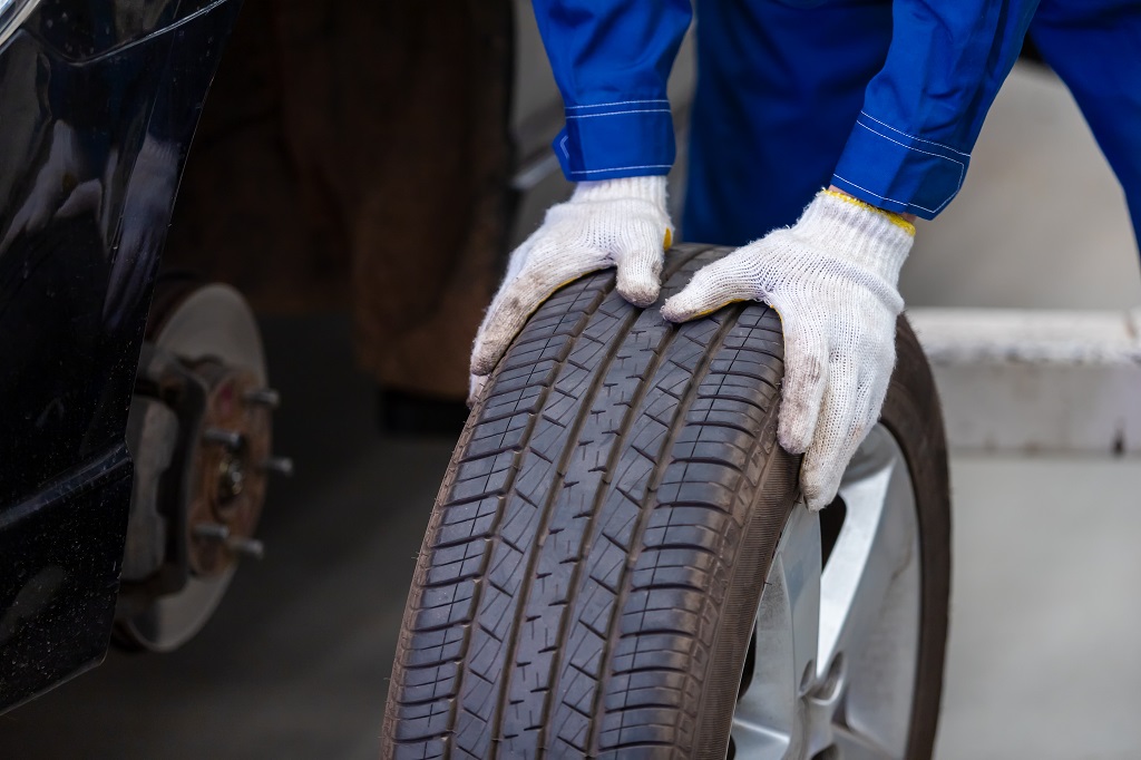 Mechanic In Uniform Is Check The Quality Of Rubber Wheels That H